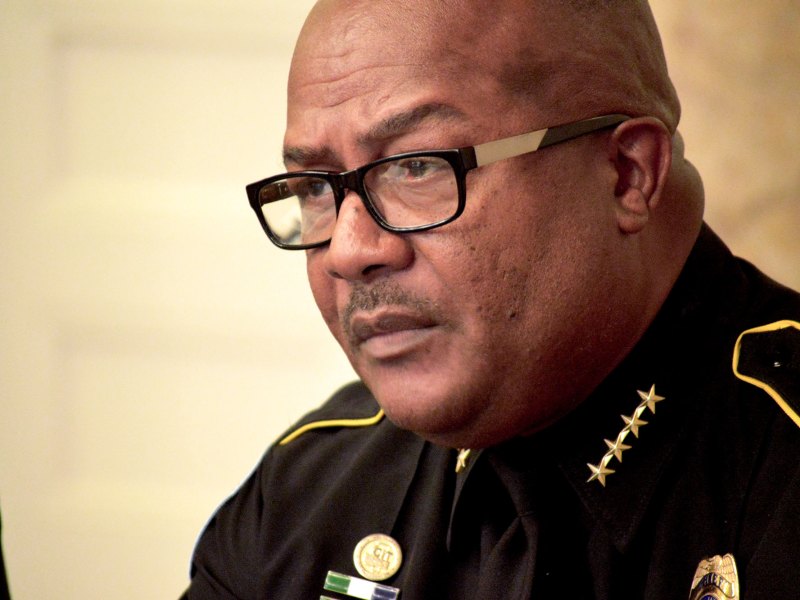 Chief Police officer at a meeting talking with media.