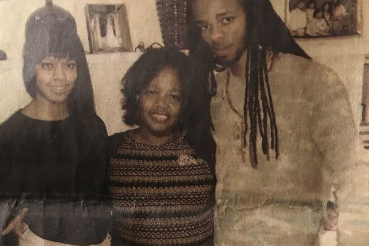 A photo of a mother and her two adult children
