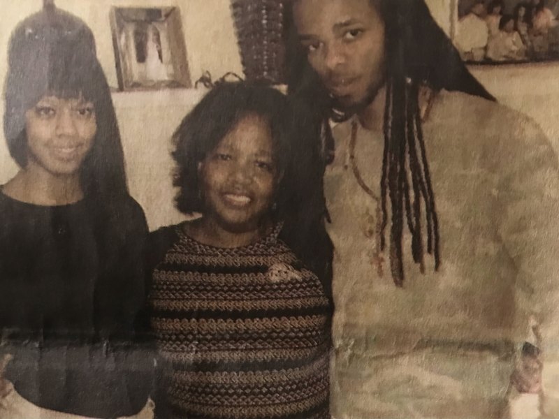A photo of a mother and her two adult children