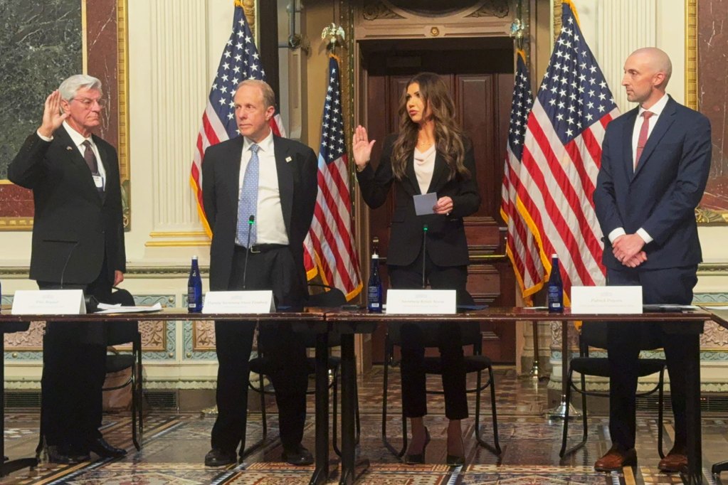 Phil Bryant and Kristi Noam perform a swearing in as two other men witness