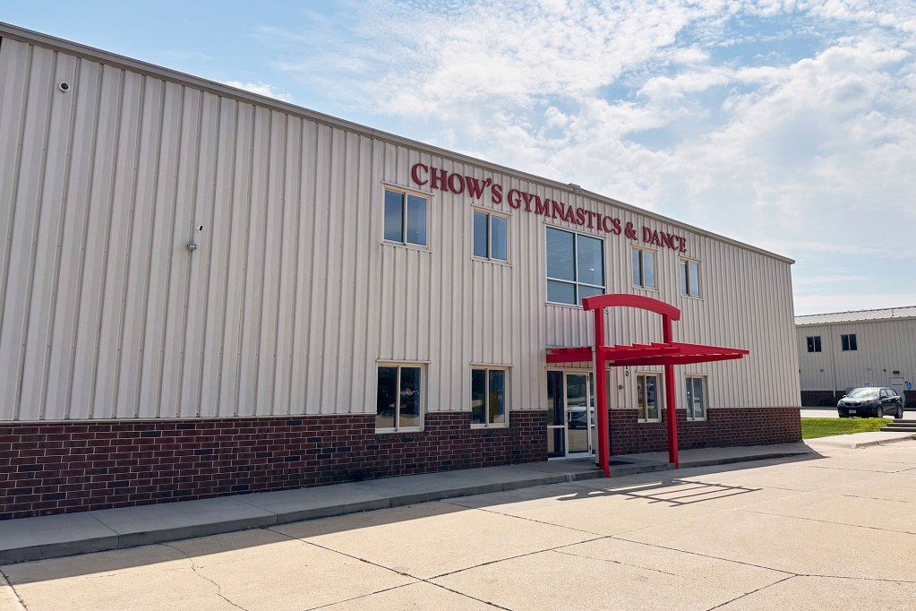 The exterior view of a two story building labeled 'Chow's Gymnastics & Dance'