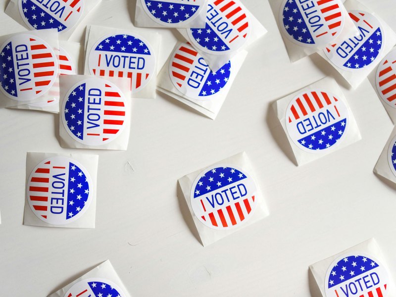 Scattered piles of stickers that say I Voted