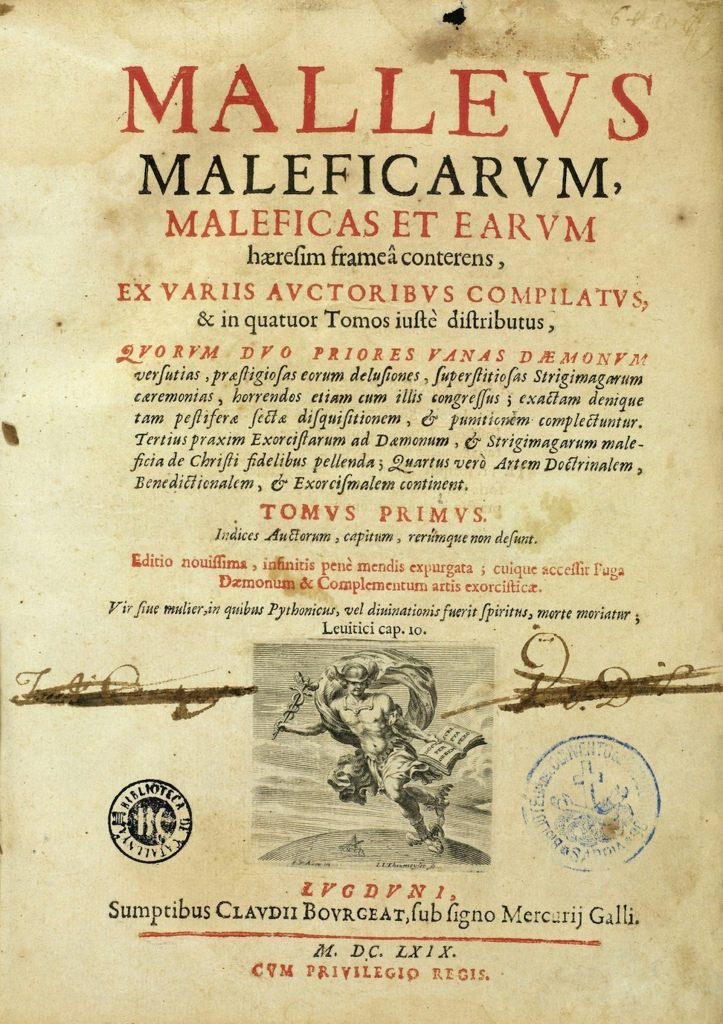 A yellowed title page from a manuscript, with print in black and red ink