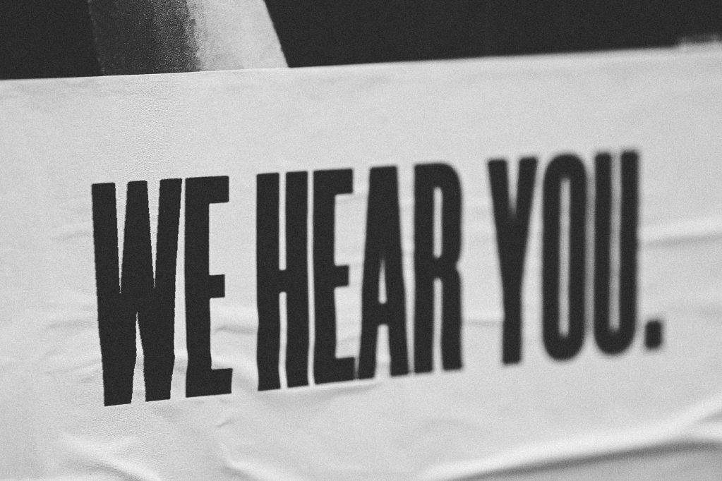 A print that reads 'WE HEAR YOU.'