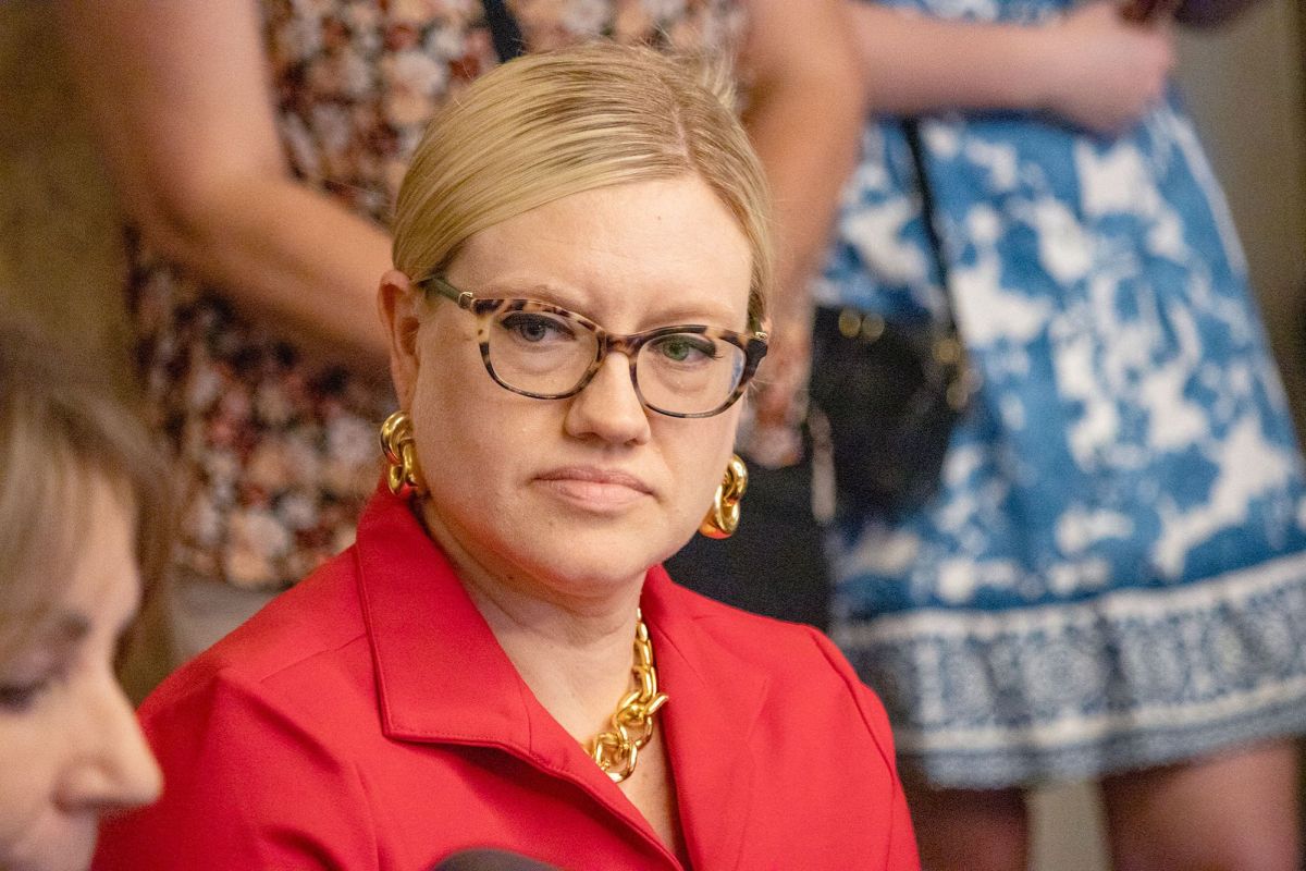 Lindsey Burke, in red, listens as someone else speaks
