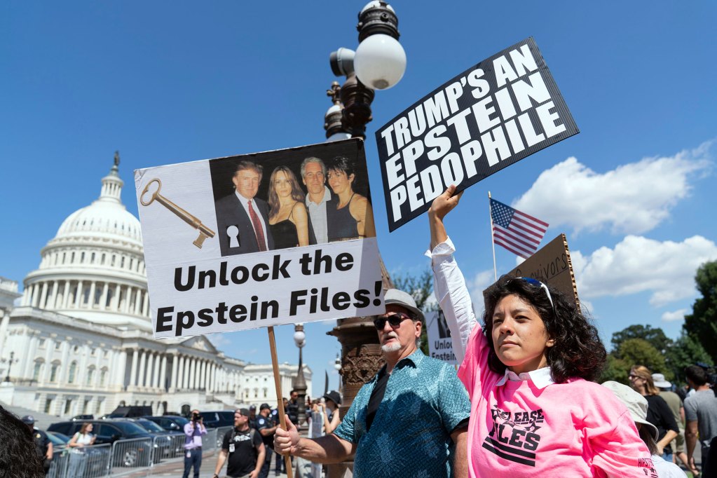 Demonstrators hold signs that read 'Unlock the Epstein Files!' and 'Trump's an Epstein Pedophile'