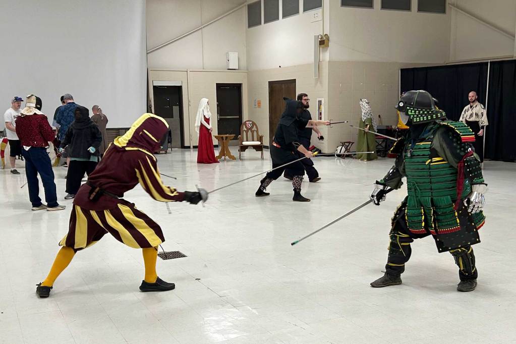 People fencing in various outfits