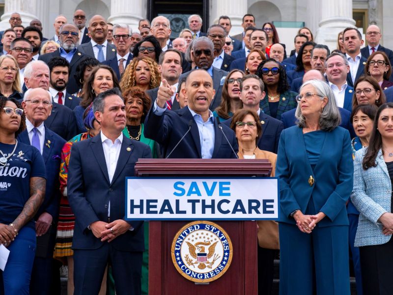 Hakeem Jeffries speaks at a podium labeled SAVE HEALTHCARE