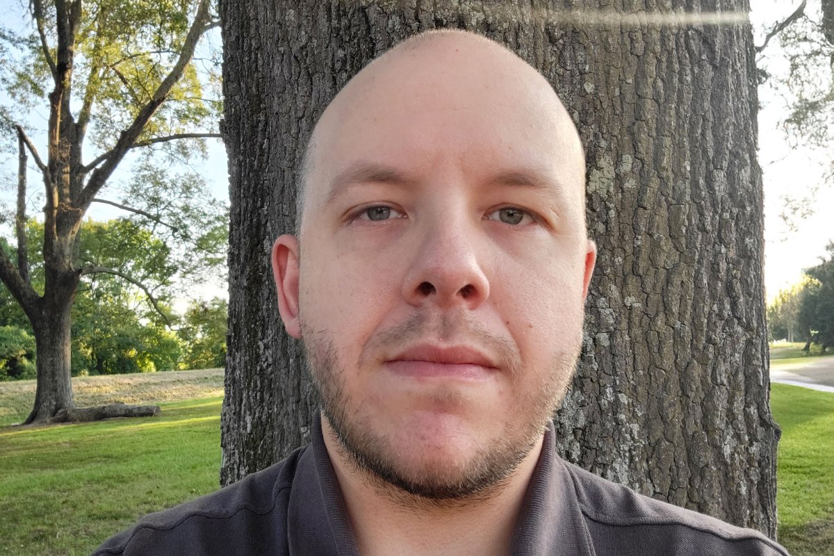 Kevin Edwards seen standing outside in front of a pecan tree