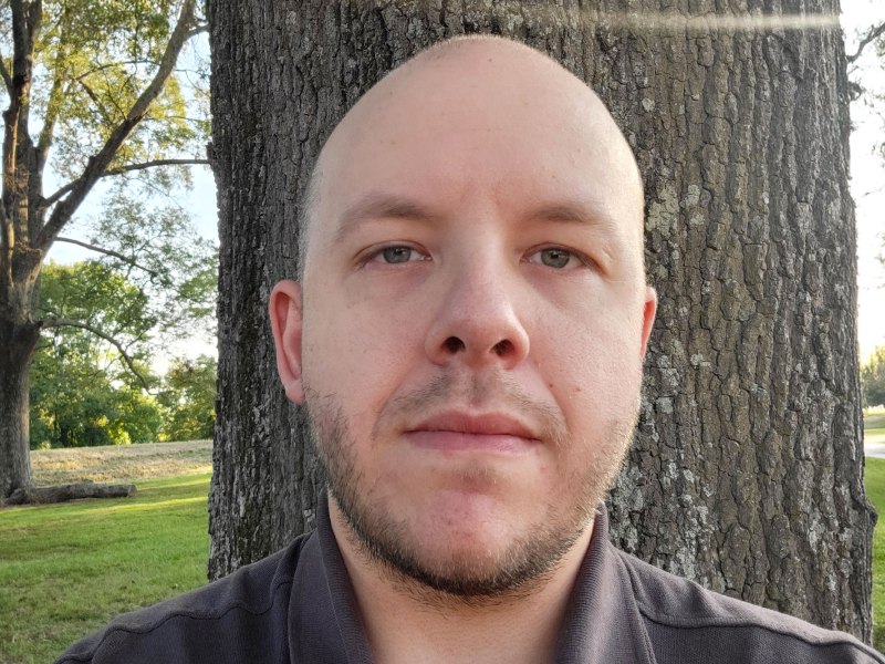 Kevin Edwards seen standing outside in front of a pecan tree