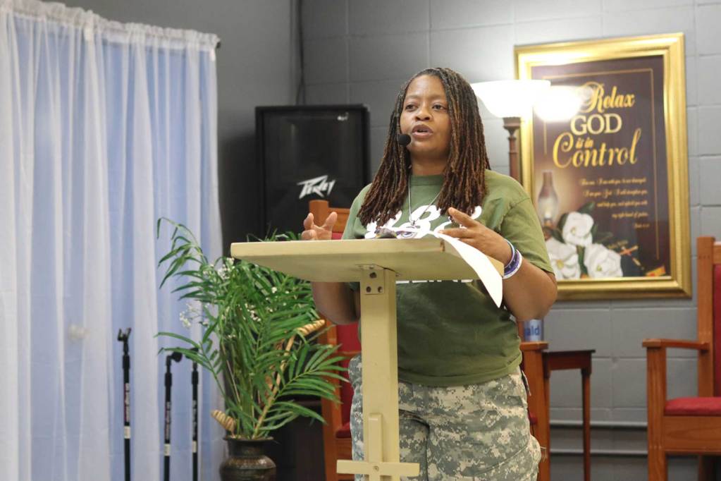 A woman speaks at a podium in a church space