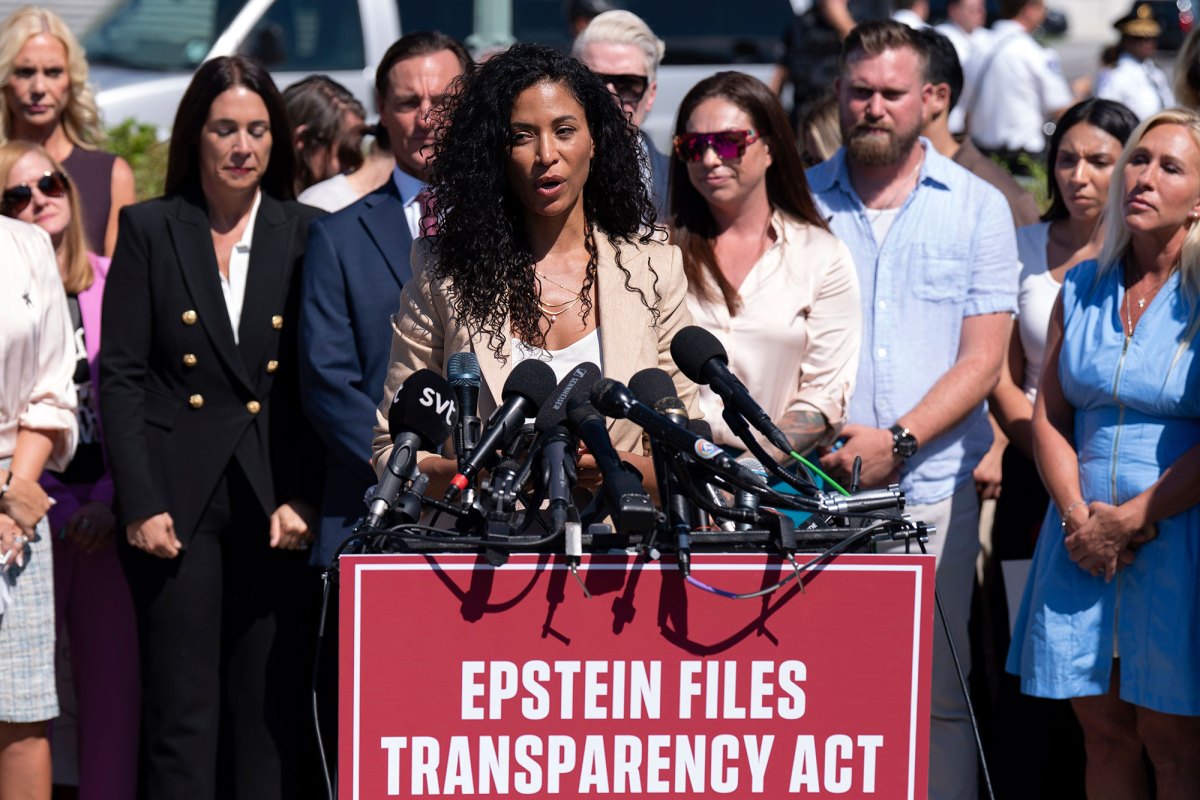 A woman speaks at a press conference outside above a sign that reads 'Epstein Files Transparency Act'