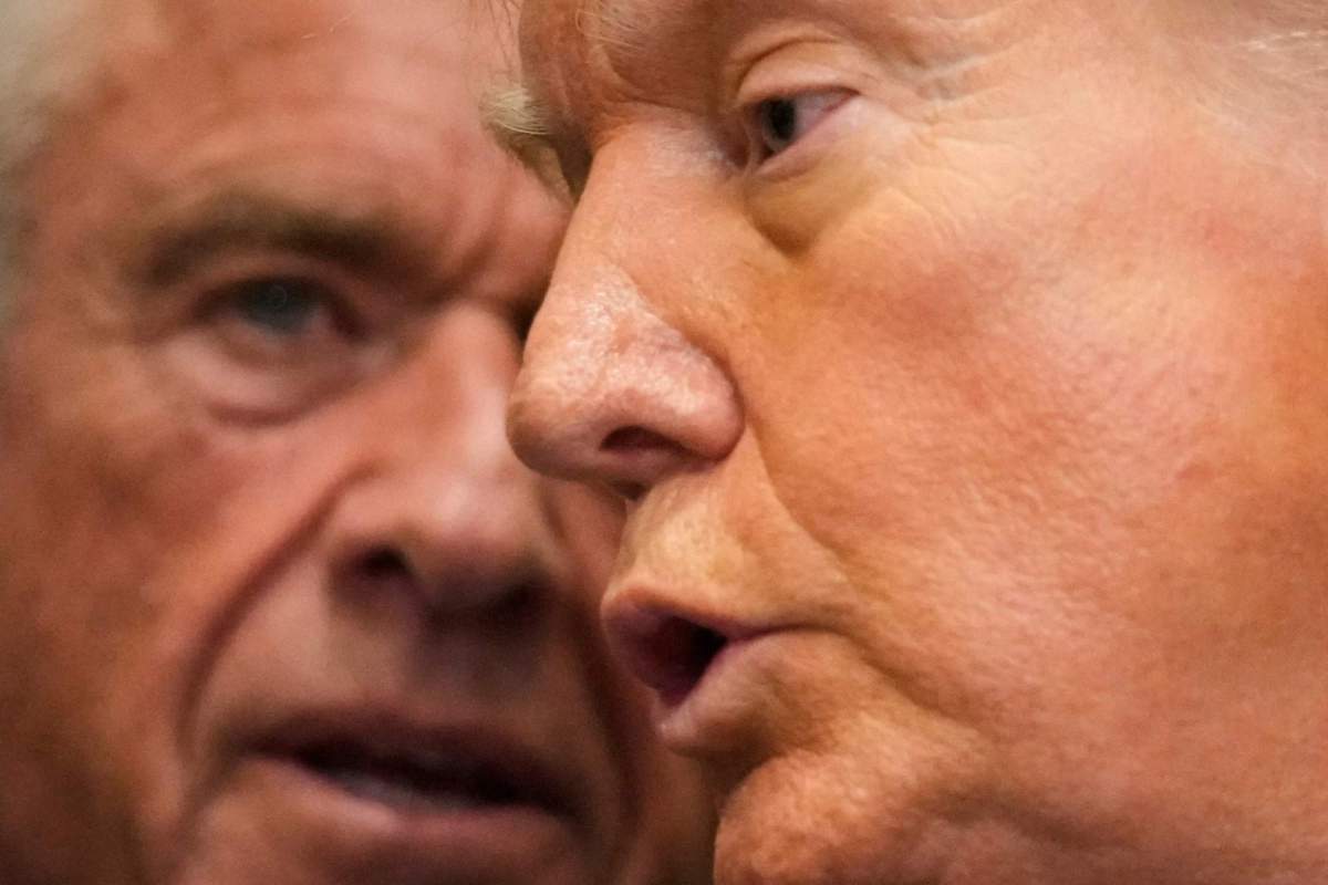 An extreme closeup of RFK Jr. and Donald Trump speaking together