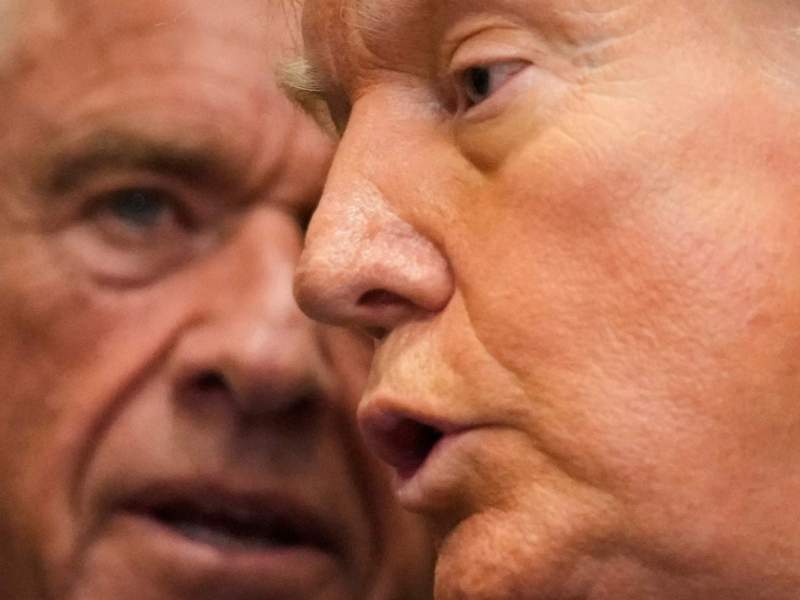 An extreme closeup of RFK Jr. and Donald Trump speaking together