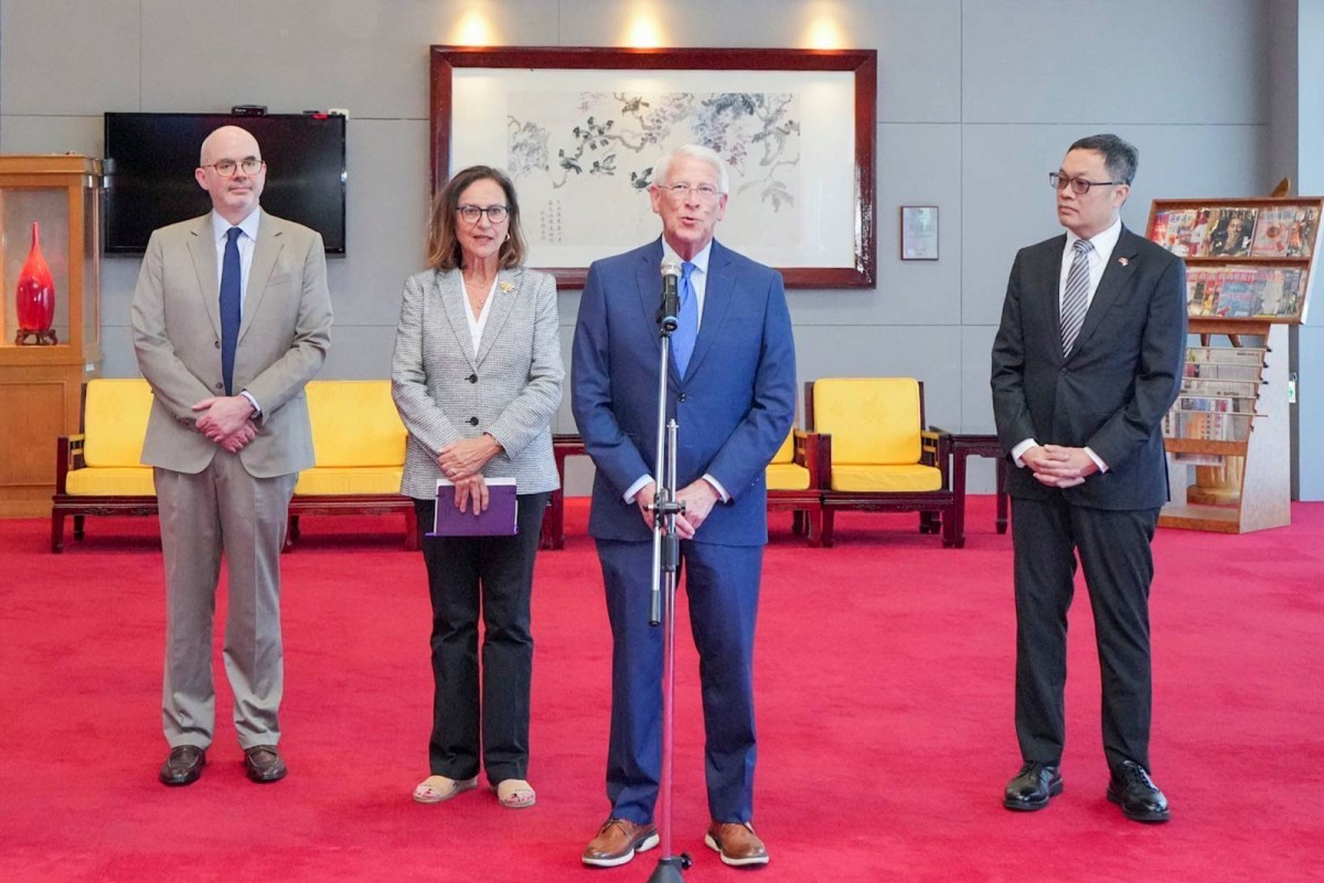 roger wicker and deb fischer stand center at a microphone while two men stand on either side of them
