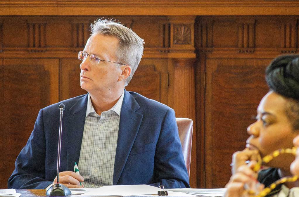 Jeff Webb sits at a committee meeting
