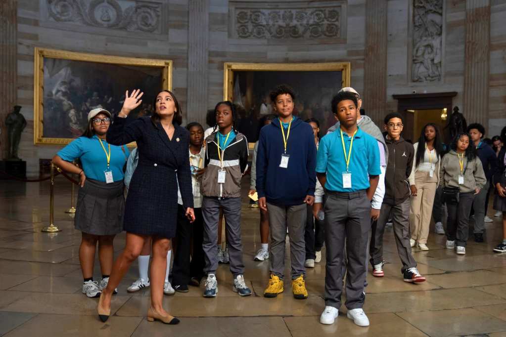 Alexandria Ocasio-Cortez leads a group of teenagers on a tour of the capitol