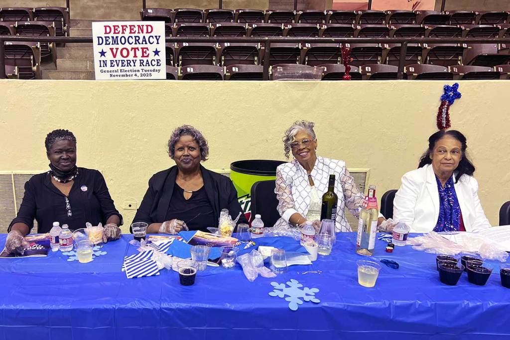 Four women seated at a table with a blue tablecloth