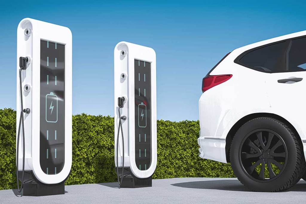A 3D illustration shows two tall, white electric charging stations, with a white vehicle parked on the right side.