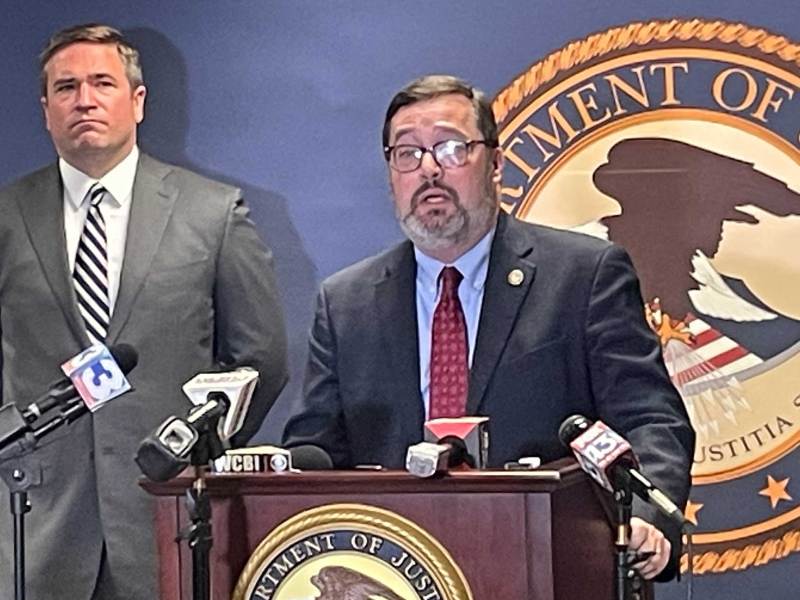 Two FBI agents give a department of justice press conference