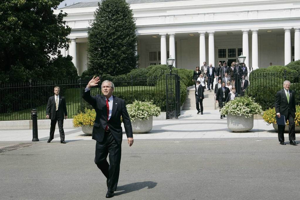 George W. Bush seen here waving as he and a crowd walk out of the East Wing of the White House