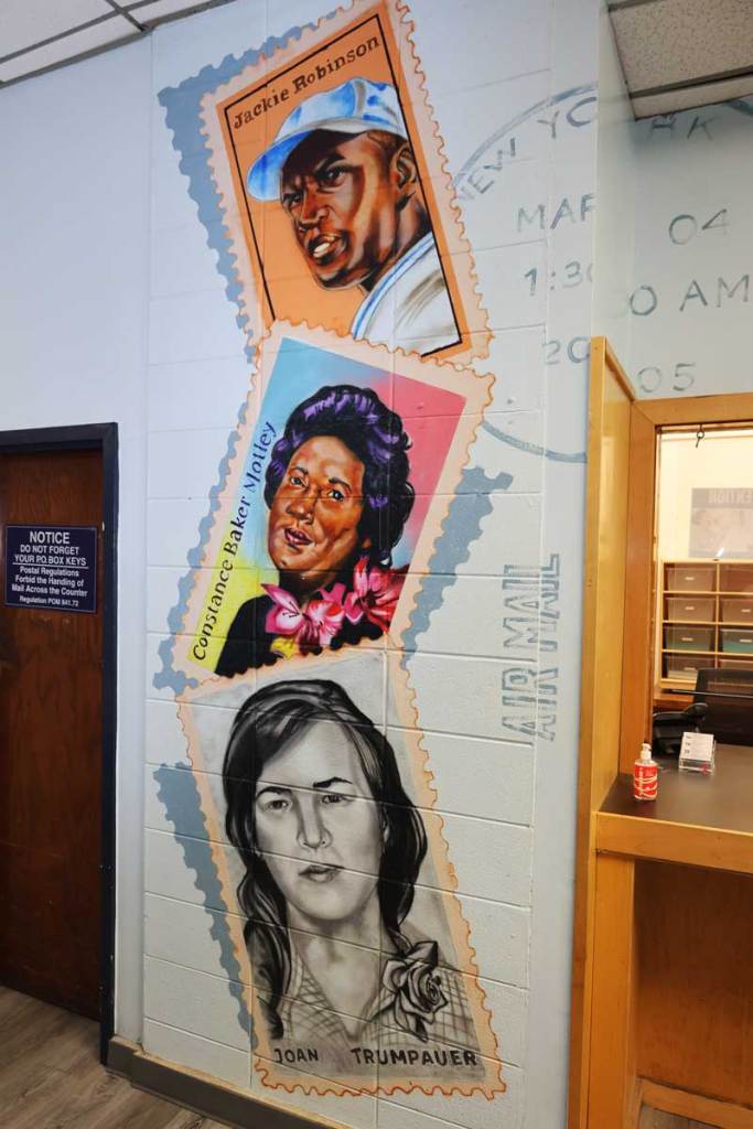 A colorful mural of three stamps depicting Jackie Robinson, Constance Baker-Motley and Joan Trumpauer