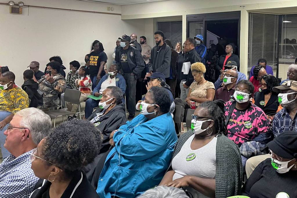 A room full of Gloster, Miss residents sit in a meeting
