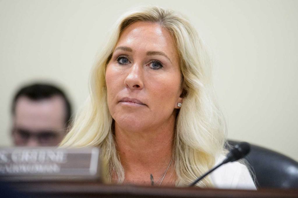 Marjorie Taylor-Greene sitting near a microphone in a hearing