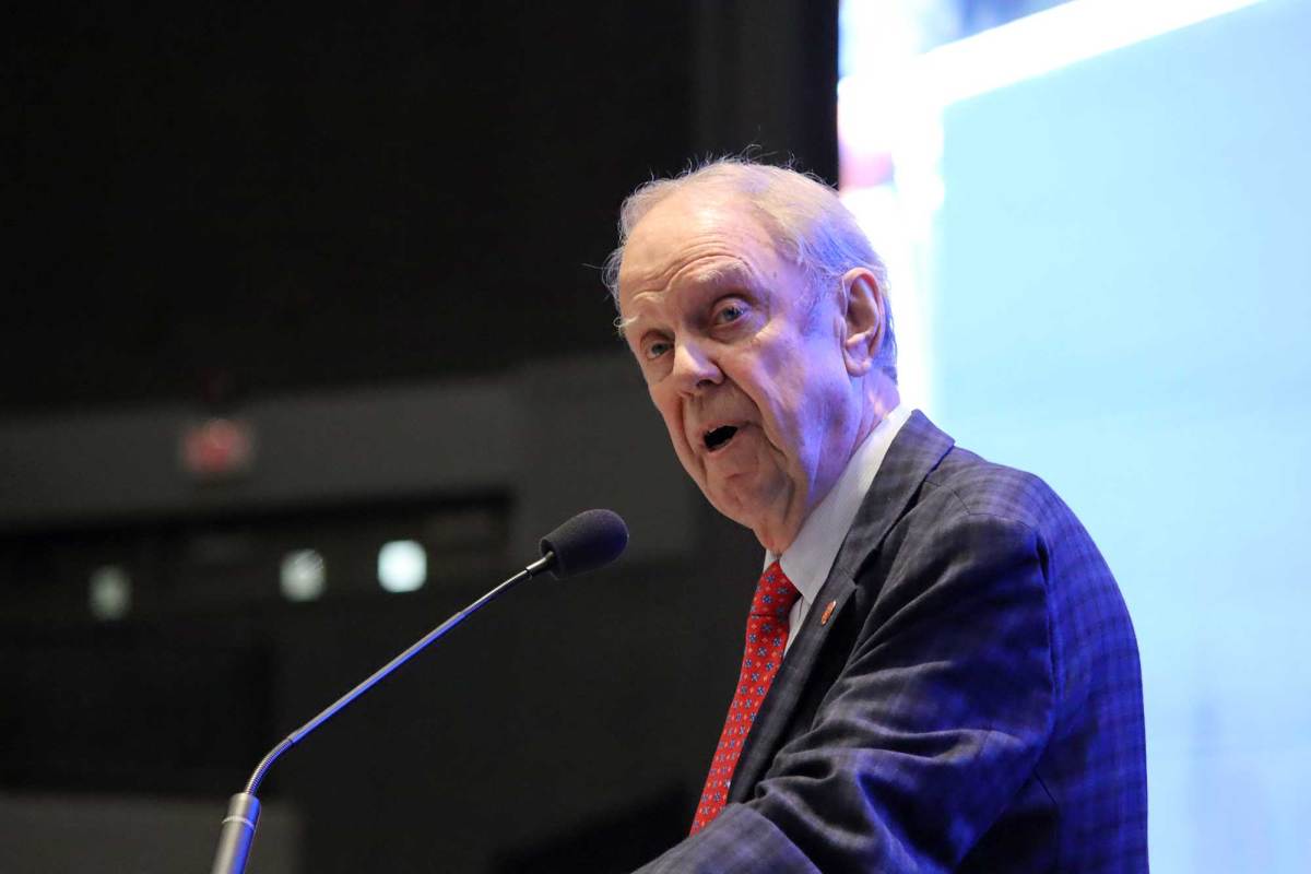 Mike Chaney speaks on stage at an indoor event