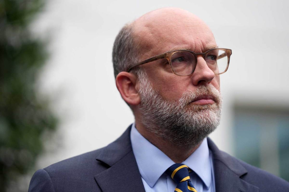 A photo of a man with a grey beard and glasses
