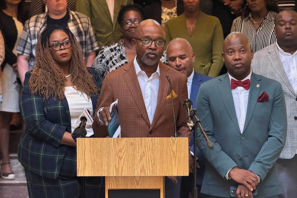 Robert Johnson speaks with people from the Southern Poverty Law Center at a press conference