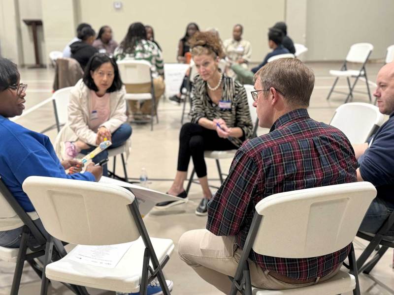 A circle of seated people talking