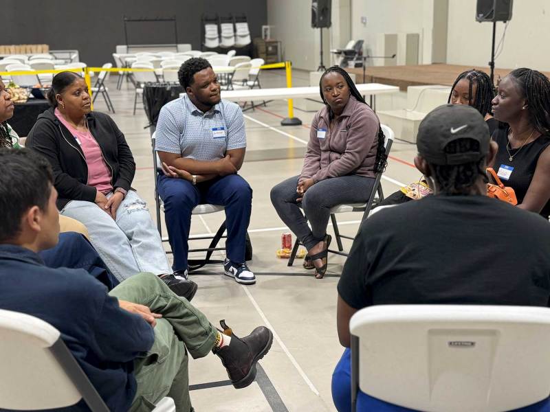 A circle of seated people talking