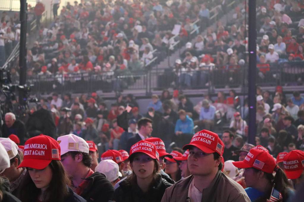 Thousands of people sit in the Sandy and John Pavilion wearing Turning Point USA and Donald Trump merchandise.