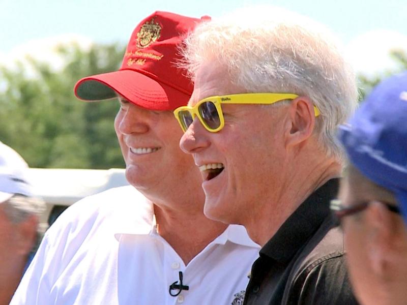 Donald Trump and Bill Clinton stand side by side at a golf course