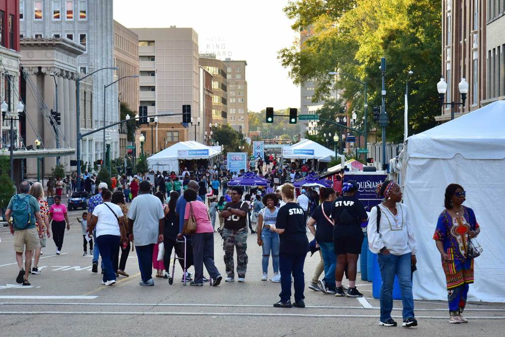 Crowds walk around the vendor section of the National Folk Festival in downtown Jackson