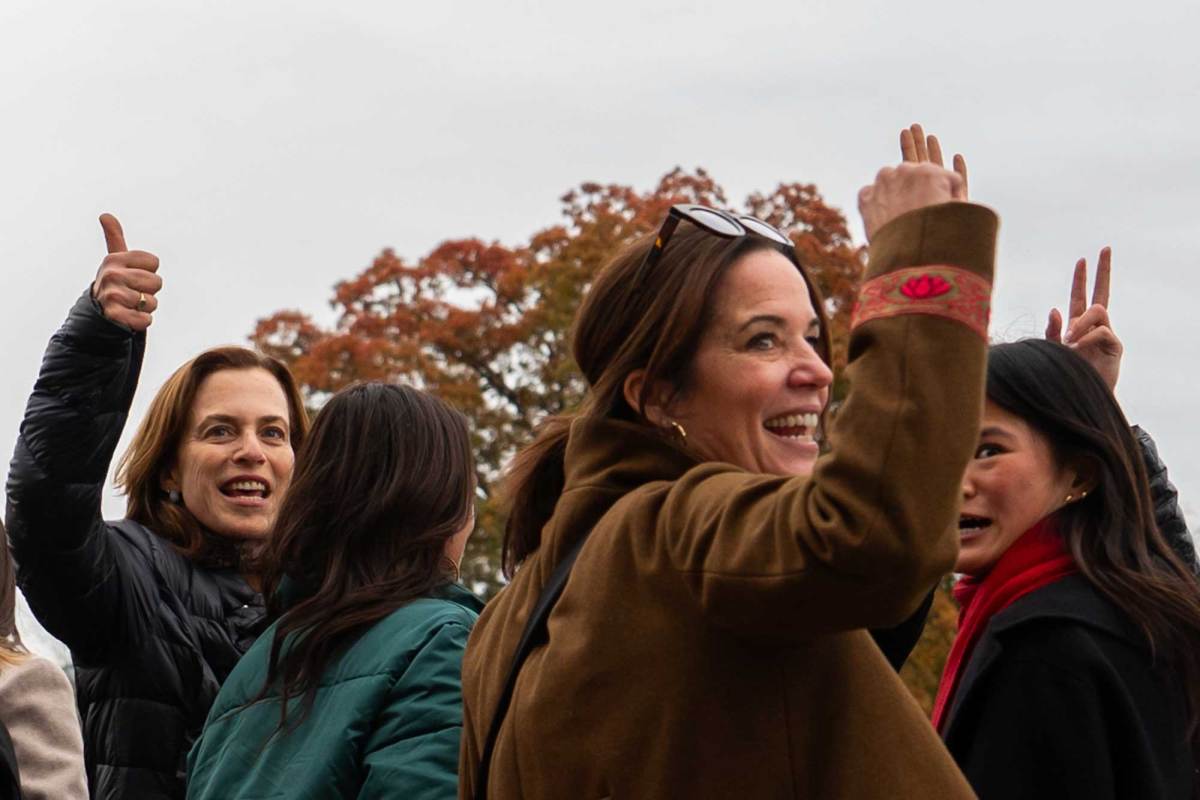 Women cheer outside after hearing some good news