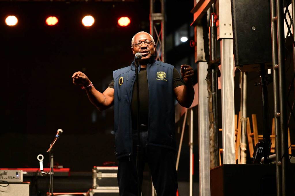 Mayor John Horhn speaks on stage at night