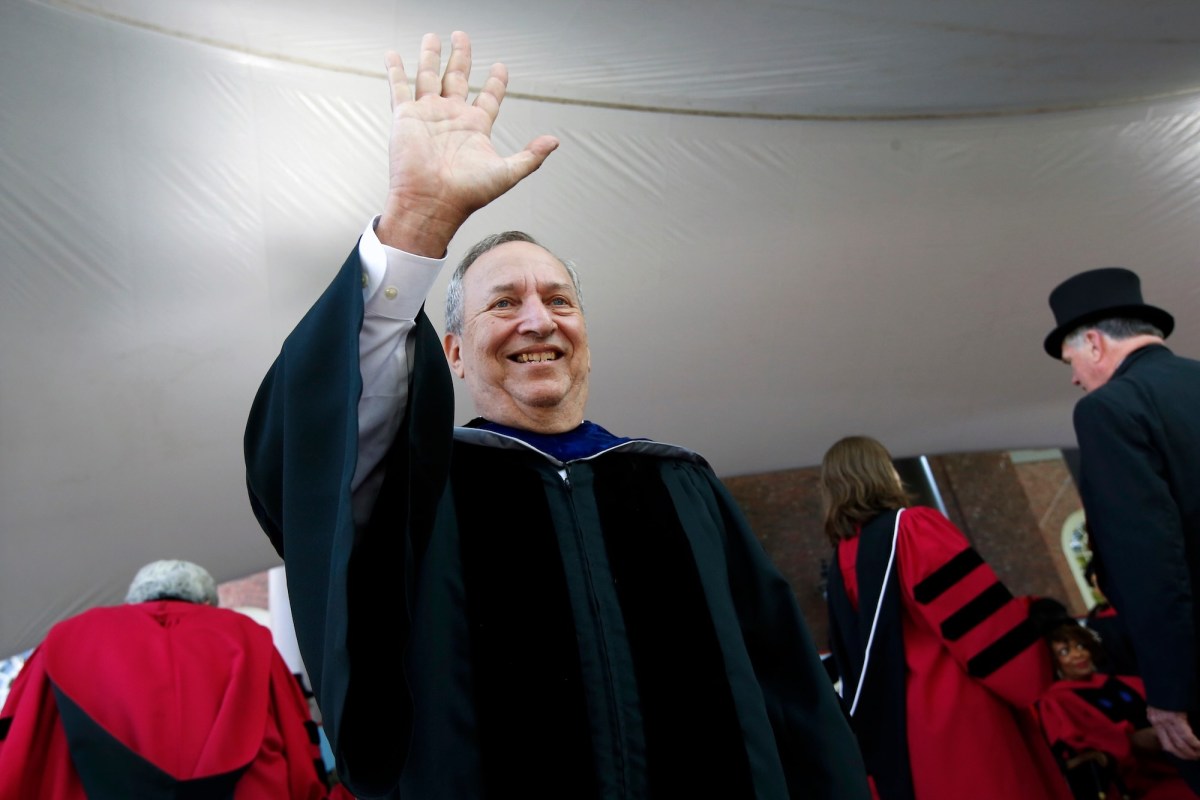 Larry Summers, an older white man, in graduation regalia