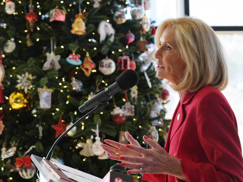 Mississippi Attorney General Lynn Fitch speaking at a press conference. A decorated Christmas tree is behind her.