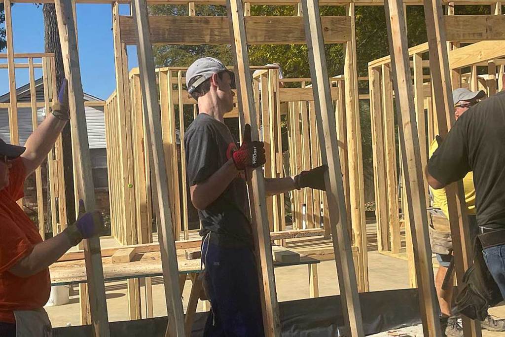 People move support structures of a house together