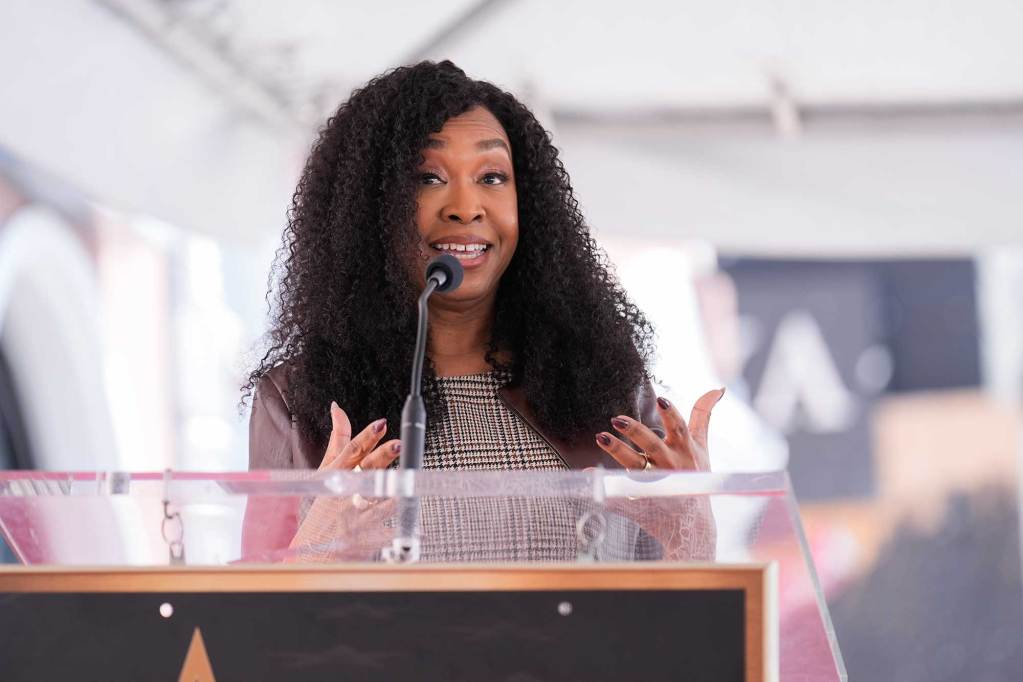 Shonda Rhimes speaks at an event in a tent outside