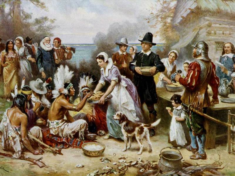 painting depicting the first Thanksgiving featuring Native Americans and Pilgrims sharing a meal