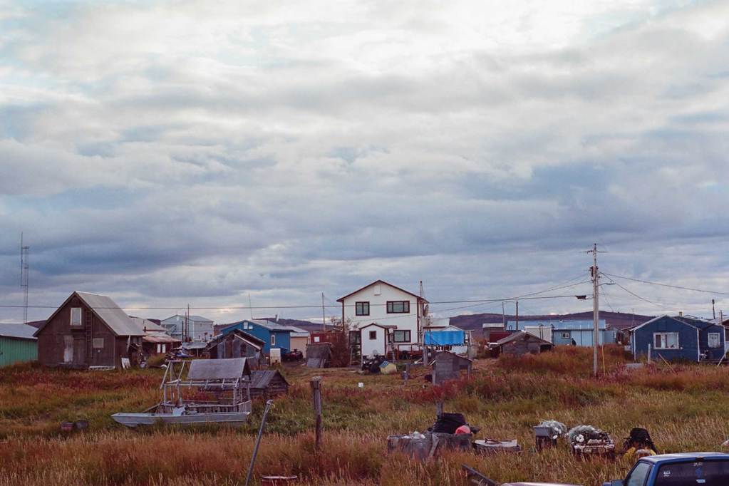 A row of houses with gray, cloudy sky in the background