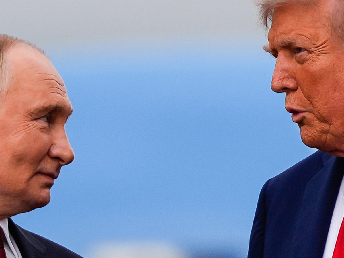 a photo of Putin smiling at Trump while trump speaks