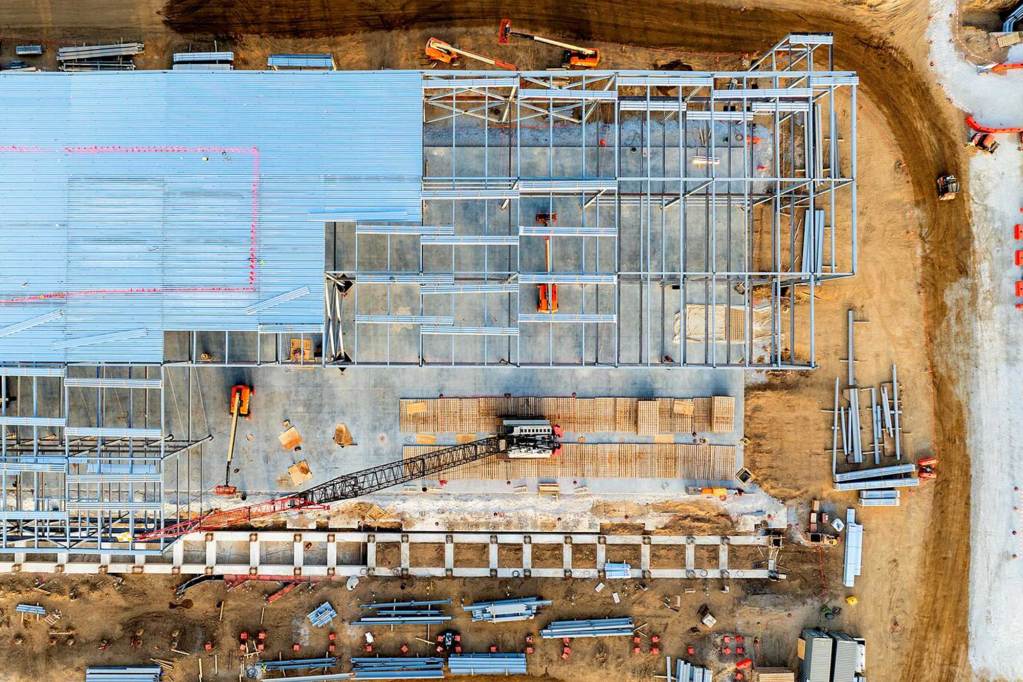 An overhead view of a large warehouse being built