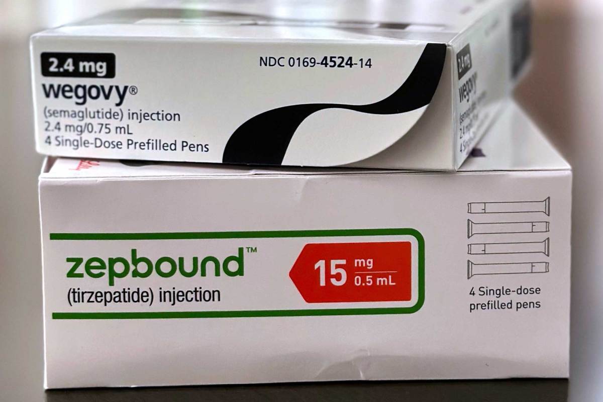 Two packages of medication stacked on top of one another. The top box reads “Wegovy” and the bottom box reads, “Zepbound.”