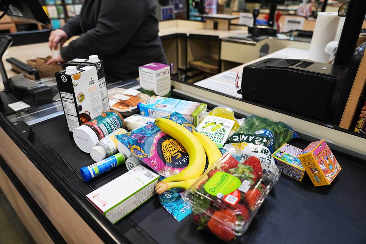 Several grocery items on a grocery counter conveyer belt