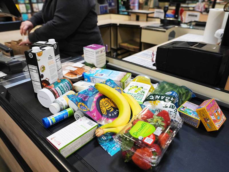 Several grocery items on a grocery counter conveyer belt