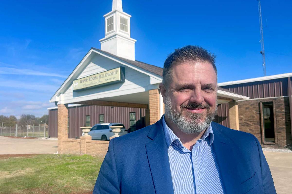 David Herndon stands outside of a church that also serves as a school